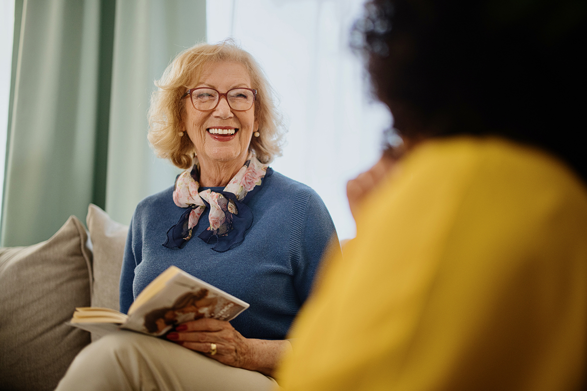 Happy senior adult laugh during book club meeting