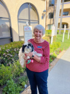 freedom village resident with her dog outside on a walk