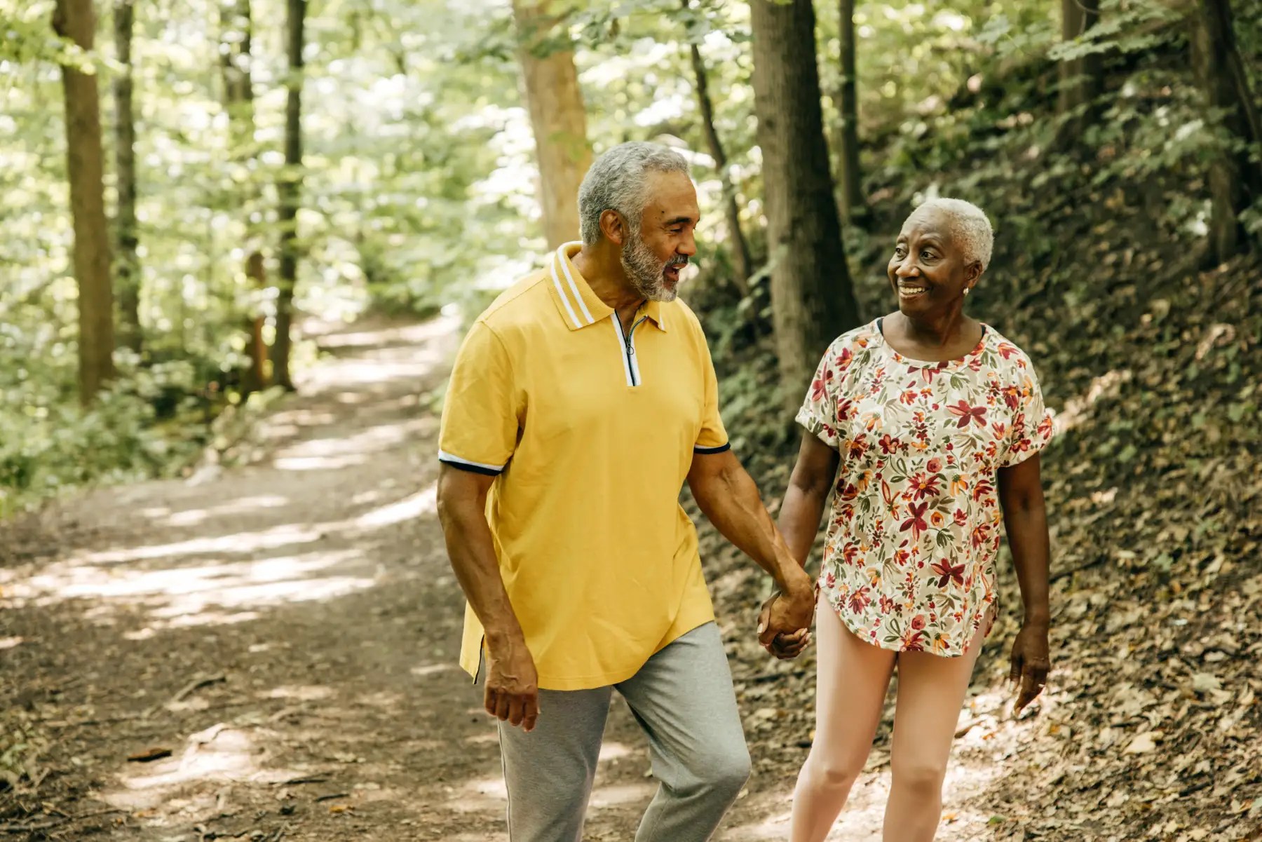 a senior couple taking an outdoor hike together