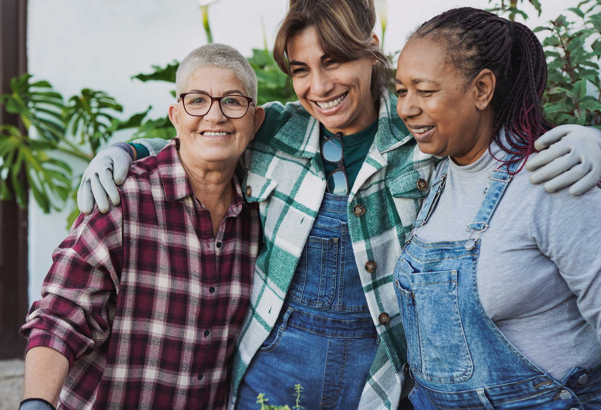 a group of senior women outside taking a break from their gardening