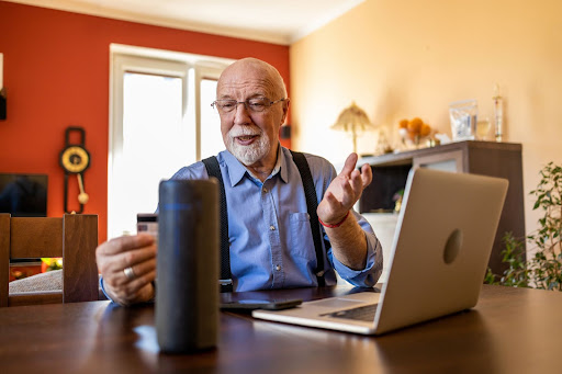 older man talking to his amazon alexa for seniors and setting an appointment reminder