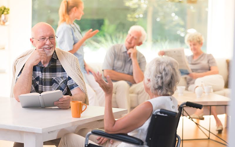 Elderly man talking with woman